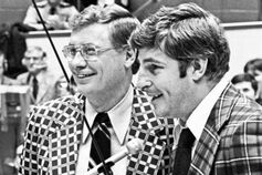 A black-and-white photo of Bob Knight standing at a podium.